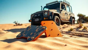 Recovery Boards positioned in sand beside a vehicle stuck in mud, highlighting their rugged design.