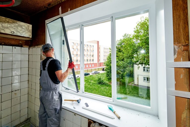 a-man-puts-a-plastic-window